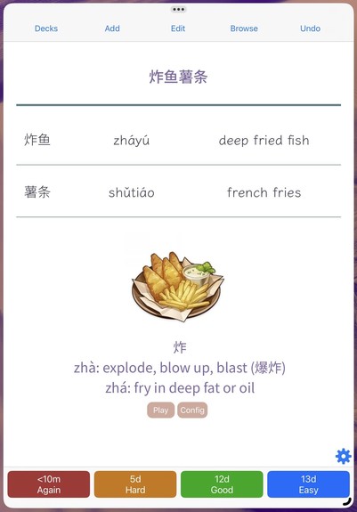 Flashcard for learning Chinese. It shows the word 炸鱼薯条 and a table with the words 炸鱼 and 薯条, their respective pronunciation and meaning in English. There’s also a picture of a game item depicting a plate of fish and chips and a text in English giving information about the character 炸.