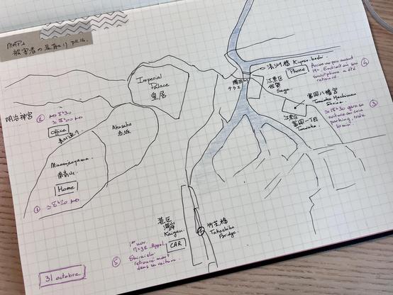 A page of a notebook showing a map roughly drawn with a pen, with a river crossing vertically and several locations noted in Japanese and English. Notations in purple describe someone’s itinerary. 
